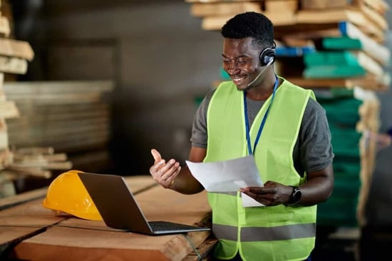 Happy black man looking at laptop displaying bulk Starbucks gift cards