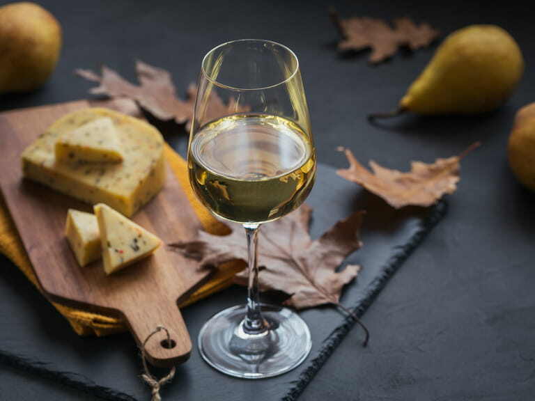 closing gifts for buyers option: A glass of white wine served with cheese