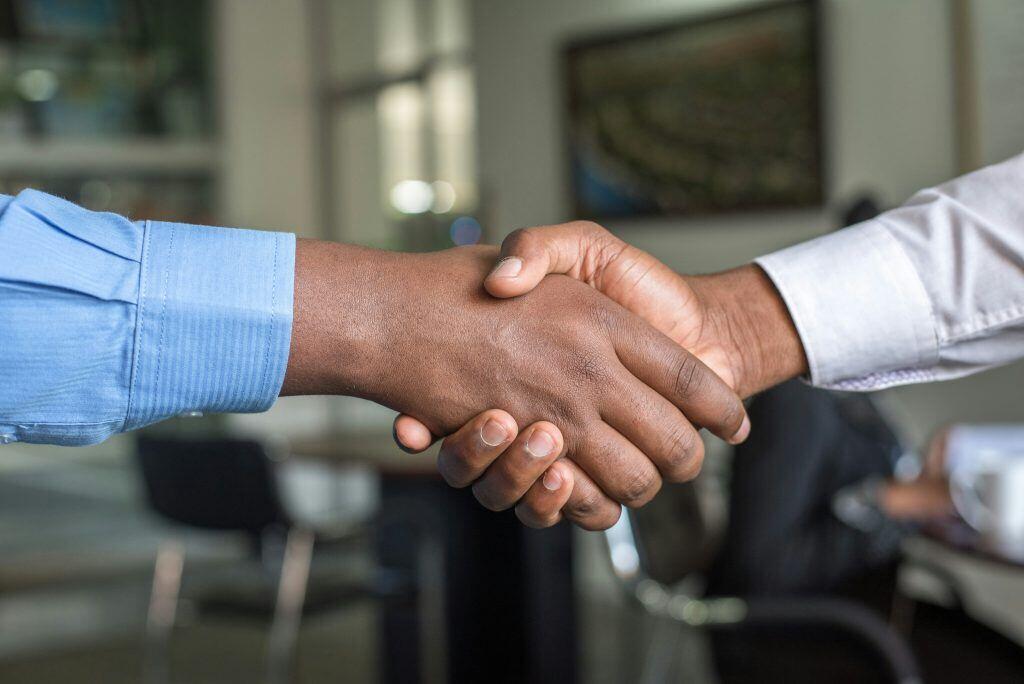 image of two people shaking hands, depicting the importance of the soft skills of customer satisfaction and client retention