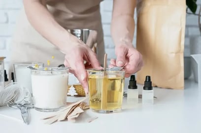 Woman setting the wooden wick in a candle