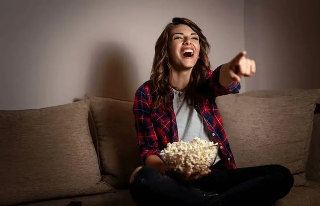 Woman watching a comedy on tv