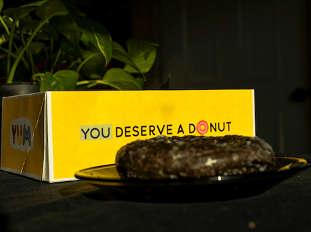 box of donuts sitting on table