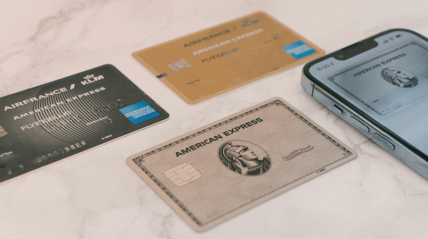 group-of-amex-cards-sitting-next-to-a-cell-phone