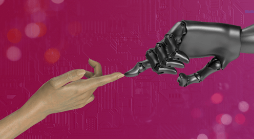 human hand touching a robot hand in pink background