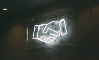 neon handshake sign