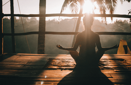 woman sitting on wooden dock