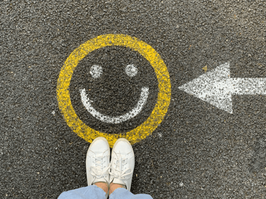 yellow smiley face on pavement